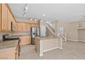 Spacious kitchen features granite countertops, stainless steel appliances, and an island with sink, perfect for modern living at 9709 Fast Elk St, Las Vegas, NV 89143