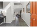Welcoming foyer with tile flooring, staircase, high ceilings, and modern decor at 10776 Maltese Falcon Ave, Las Vegas, NV 89129