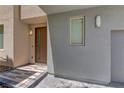 Townhome entrance featuring stone steps, modern lighting, stucco walls, and neutral trim at 11377 Gravitation Dr, Las Vegas, NV 89135