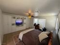 This bedroom features custom built-in cabinets, a ceiling fan, and warm lighting for a cozy feel at 1146 Olivia Pkwy, Henderson, NV 89011