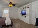 Bright bedroom featuring custom built-ins, a ceiling fan, and wood-look flooring at 1146 Olivia Pkwy, Henderson, NV 89011