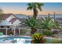 Backyard view showcasing lush desert landscaping, pool and spa area, and city views at 1239 N Hollywood Blvd, Las Vegas, NV 89110