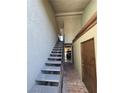 Condo entryway featuring tiled walkway and stairs with metal railing leading upstairs at 1460 Hialeah Dr # D, Las Vegas, NV 89119
