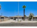 Cozy single-story home with a desert landscape, block wall, and gated entrance at 1641 K St, Las Vegas, NV 89106