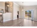 Open living space with hardwood floors, high ceilings, a staircase and access to the backyard at 1804 Michael Ct, Henderson, NV 89014
