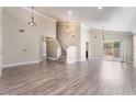Spacious living room with high ceilings, lots of light, and hardwood floors leading to a staircase at 1804 Michael Ct, Henderson, NV 89014
