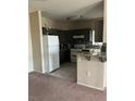 Open kitchen featuring gray cabinets, granite counters, and stainless steel appliances at 1830 N Buffalo Dr # 2021, Las Vegas, NV 89128