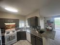 Contemporary kitchen featuring granite counters, stainless steel appliances, and a decorative backsplash at 1830 N Buffalo Dr # 2021, Las Vegas, NV 89128