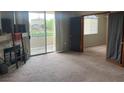 Comfortable living room with a fireplace, balcony access, and connecting doors to another room at 1830 N Buffalo Dr # 2021, Las Vegas, NV 89128