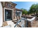 Inviting front patio with stone accents, an ornate gate, and comfortable outdoor seating at 2188 Cumberland Hill Dr, Henderson, NV 89052