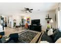 Spacious living room featuring tile flooring, a ceiling fan, and ample natural light at 2188 Cumberland Hill Dr, Henderson, NV 89052