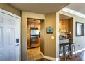 Cozy kitchen entrance featuring stainless steel appliances, tiled floors, and a breakfast bar at 220 E Flamingo Rd # 317, Las Vegas, NV 89169