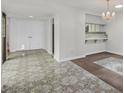 Open dining area with unique flooring, chandelier, and kitchen view at 2558 La Fortuna Ave, Las Vegas, NV 89121