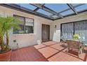 Covered patio featuring tile flooring, outdoor seating, and sliding glass door at 2558 La Fortuna Ave, Las Vegas, NV 89121