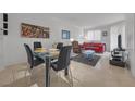 Open-plan living and dining area furnished with modern decor, including a glass-top dining table and sofa at 270 E Flamingo Rd # 106, Las Vegas, NV 89169
