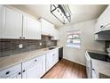 Modern kitchen features updated appliances, grey tile backsplash, and updated countertops at 3135 La Mesa Dr, Henderson, NV 89014