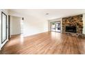 Spacious living room features a stone fireplace and sliding doors to the outdoor patio at 3135 La Mesa Dr, Henderson, NV 89014