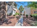 View of condo buildings exterior with desert landscaping, shrubs and sidewalk at 3151 Soaring Gulls Dr # 2050, Las Vegas, NV 89128