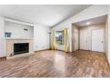 Spacious living room featuring a cozy fireplace, natural light, and hardwood floors at 371 Cambray St, Henderson, NV 89074