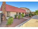 Attractive townhouses with red tile roofs, set amongst neatly manicured landscaping at 3907 Torsby Pl, Las Vegas, NV 89119