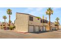 Inviting townhome complex featuring private garages and well-maintained exteriors surrounded by palm trees at 5043 Spencer St # A, Las Vegas, NV 89119