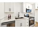 Modern kitchen features stainless steel appliances and sleek black hardware at 5078 Mountain Vista St, Las Vegas, NV 89120