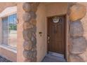 Inviting entryway with decorative stonework accents around the front door and nearby window at 5228 Giallo Vista Ct, North Las Vegas, NV 89031