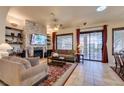 Inviting living room with a stone fireplace, comfortable seating, and sliding door access to the patio at 561 Carmel Valley St, Henderson, NV 89012