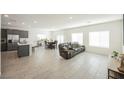Open-concept living room with tile flooring, ample natural light, and stylish furniture at 6148 Vista Teal Ln, Las Vegas, NV 89115