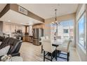 Open kitchen and dining area features stainless steel appliances and natural light from a large window at 63 E Agate Ave # 509, Las Vegas, NV 89123
