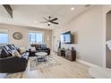 Open living room features recessed lighting, ceiling fan, and a large window with neighborhood views at 63 E Agate Ave # 509, Las Vegas, NV 89123