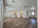 Spacious living room with hardwood floors showcases an open floor plan, connecting seamlessly to the kitchen at 6638 Babys Tear Pl, Las Vegas, NV 89148