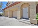 Home with garage and entryway, featuring a secure screen door and stucco walls at 690 Ambling Gait Ave, Henderson, NV 89015