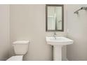 Elegant half bathroom with modern fixtures, a pedestal sink, and a decorative wall at 8048 Skye Bridge St, Las Vegas, NV 89166