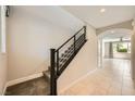 Bright hallway with a staircase and tiled floors, leading to a naturally lit living area at 8048 Skye Bridge St, Las Vegas, NV 89166