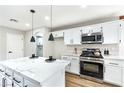 Bright kitchen with stainless steel appliances, a large island, and modern pendant lighting at 8113 Bay Springs Dr, Las Vegas, NV 89128