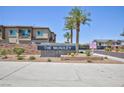 A community sign with the name The McAuley set amongst desert landscaping at 835 Aurelie Ridge St, Henderson, NV 89011