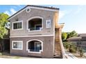 Two-story condo building with neutral paint, white trim, and stair access to upper units at 9330 W Maule Ave # 138, Las Vegas, NV 89148
