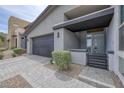 Modern home with a flat roof, two-car garage, and stone driveway at 9789 Twilight Moon Ave, Las Vegas, NV 89148