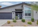 Modern home with a flat roof, two-car garage, and desert landscaping at 9789 Twilight Moon Ave, Las Vegas, NV 89148