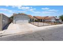 Inviting single-story home showcases a two-car garage and a secure fenced yard enhancing curb appeal at 1012 Greystone Dr, Las Vegas, NV 89108