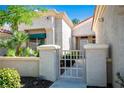 Inviting front entrance with a charming gate and desert landscaping at 10305 Snyder Ave, Las Vegas, NV 89134