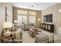 Bright living room featuring neutral tones, plush seating, and large windows offering ample natural light at 10305 Snyder Ave, Las Vegas, NV 89134