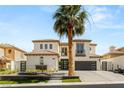 Beautiful two-story home with a tile roof, attached garages, and professional landscaping at 11453 Glowing Sunset Ln, Las Vegas, NV 89135