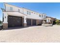 Spacious driveway leading to a three-car garage and beautifully landscaped home with ample parking at 1319 Red Baron Ln, Boulder City, NV 89005