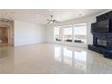 Bright, open living room with large windows, tile floors, and a modern fireplace for relaxation at 1319 Red Baron Ln, Boulder City, NV 89005