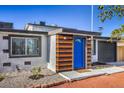 The house features a vibrant blue front door and modern wood accents at 1564 Vegas Valley Dr, Las Vegas, NV 89169
