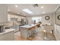 Bright kitchen featuring quartz countertops, stainless steel appliances, and an island with bar stool seating at 1564 Vegas Valley Dr, Las Vegas, NV 89169