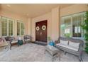 Inviting courtyard area with elegant double doors, seating, and stylish decor at 16 Mallard Creek Trl, Henderson, NV 89052