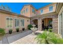 Beautiful courtyard featuring a fountain, stone archway, and comfortable seating area at 16 Mallard Creek Trl, Henderson, NV 89052
